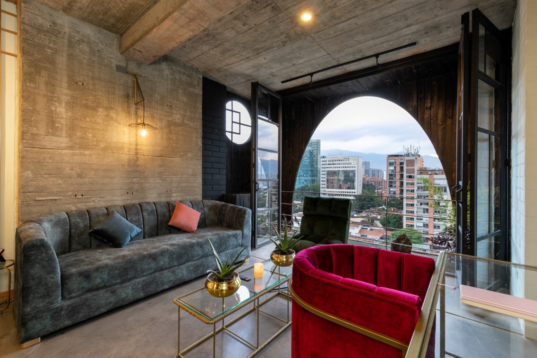 Spacious and well-lit living room in Hotel Medellin Nido Sky with designer furniture